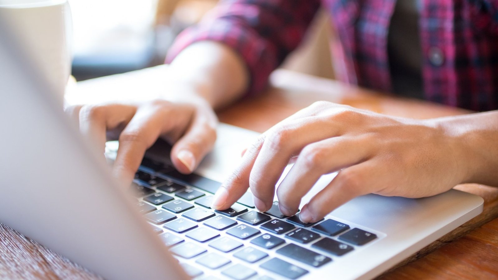 Person typing on a laptop to request a remodeling estimate online